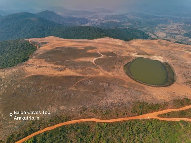 Aerial view of the Balda plateau, with open ground and a hilltop pond